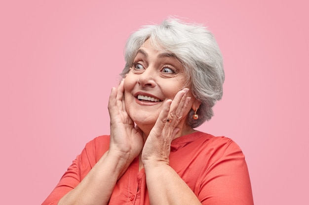 Excited elderly lady looking away