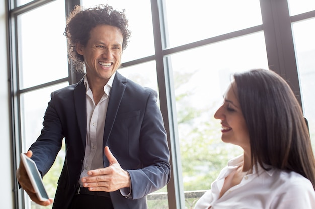 Excited emotional Asian man showing report