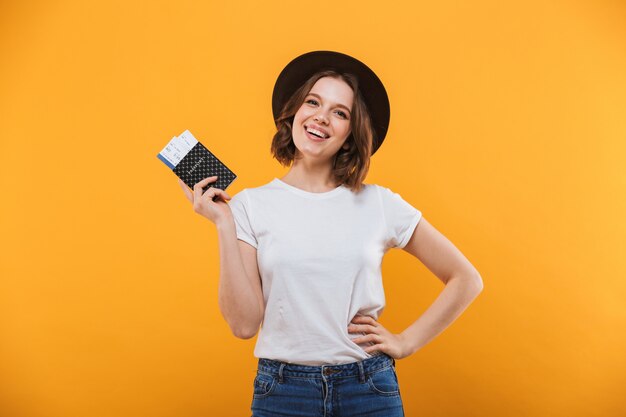 Excited emotional young woman tourist holding passport