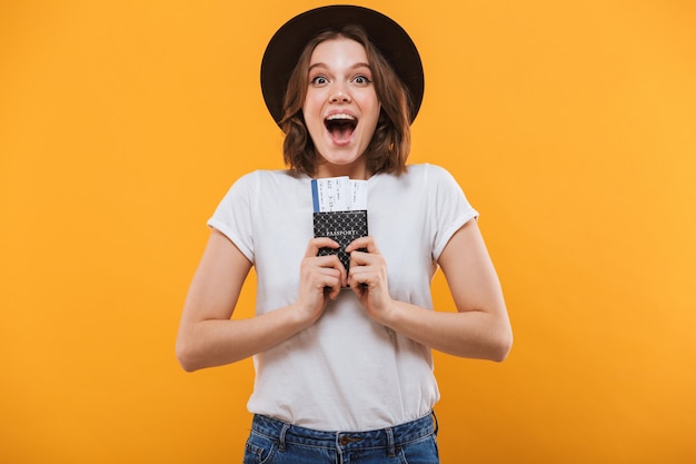 Excited emotional young woman tourist holding passport