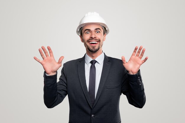 Excited engineer in hardhat and suit