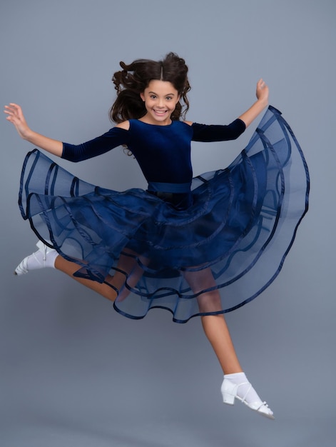 Excited face cheerful emotions of teenager girl Happy teenager positive and smiling emotions Full length of excited teenager child in summer dress jump isolated on gray background studio