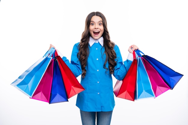 Excited face Shopping bags in the kids hands Teen girl after shopping Purchases black friday discounts and sale concept Amazed expression cheerful and glad