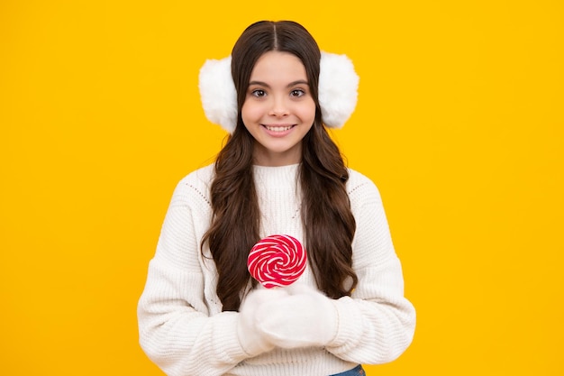 Excited face Teenage girl with candy lollipop happy child 12 13 14 years old eating big sugar lollipop sweets candy Happy face positive and smiling emotions of teenager girl