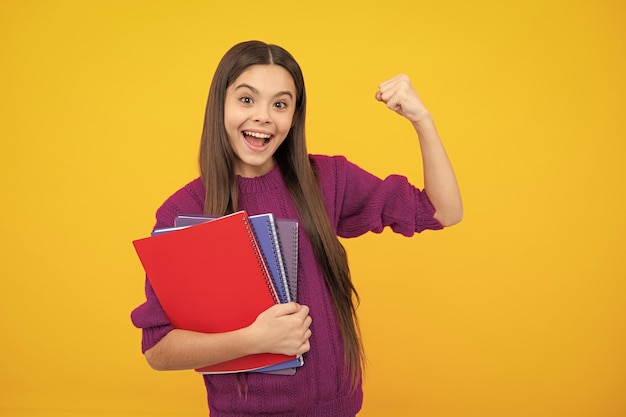Excited face teenager school girl with books isolated studio background amazed expression cheerful and glad