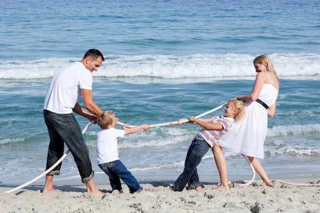 Excited family playing tug of war 