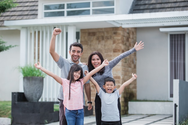 Excited family with kids raised arm