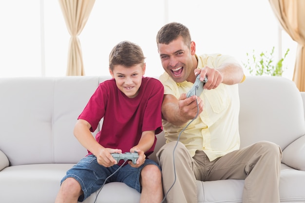 Excited father and son playing video game