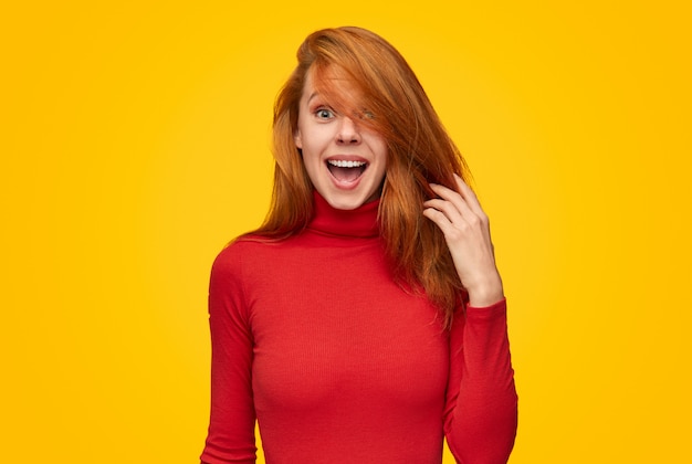 An excited female model is touching her hair