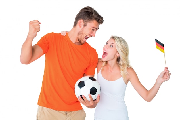 Excited football fan couple cheering 