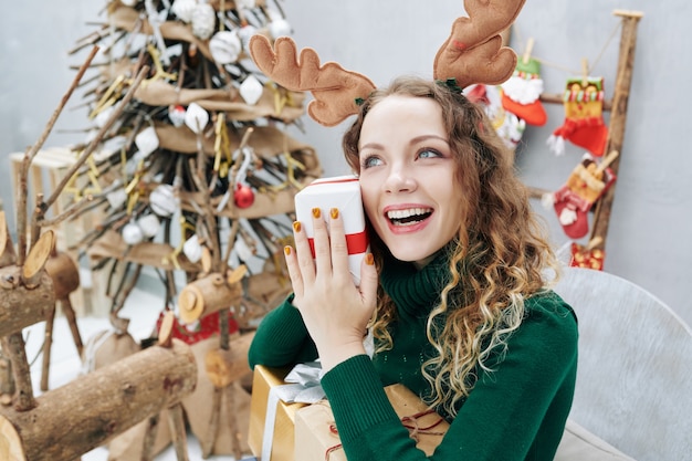 Excited girl holding Christmas present