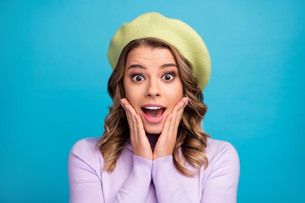 Excited girl put hands on face scream loud over blue background