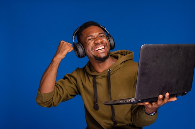 Excited guy using laptop and headset