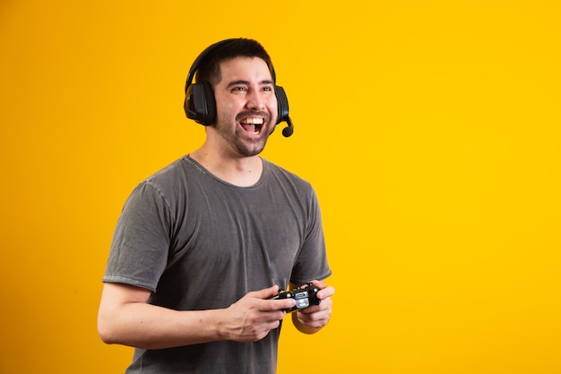 Excited handsome man playing video game