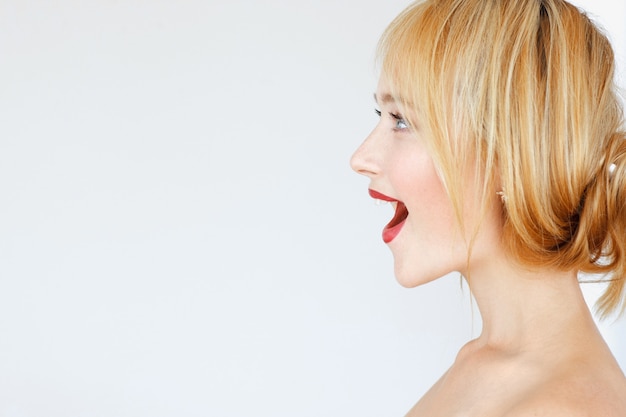 Excited happy red-haired woman profile