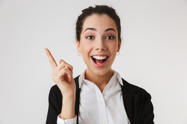 Excited happy young business woman pointing