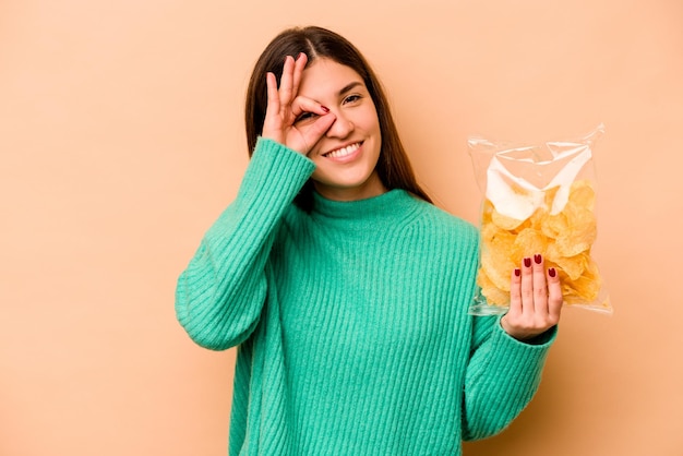 Excited keeping ok gesture on eye