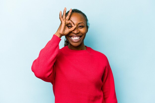 Excited keeping ok gesture on eye