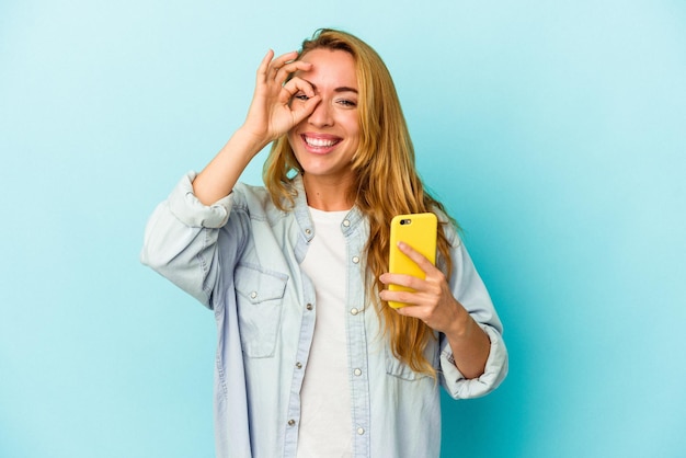 Excited keeping ok gesture on eye