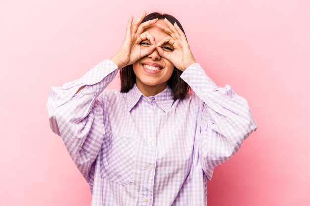 Excited keeping ok gesture on eye