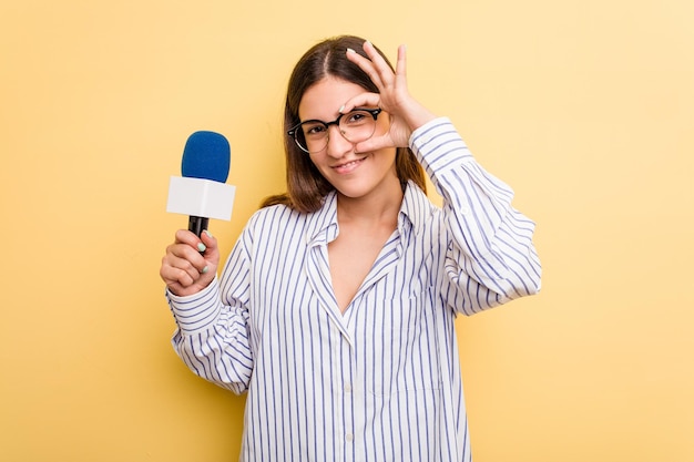 Excited keeping ok gesture on eye