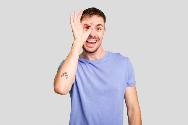 Excited keeping ok gesture on eye