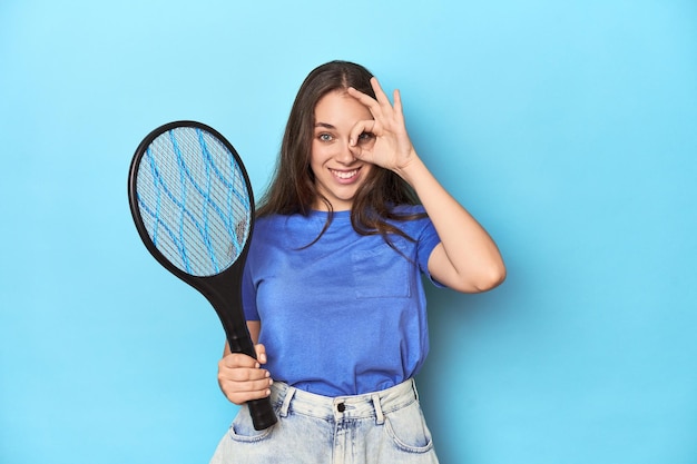 Excited keeping ok gesture on eye