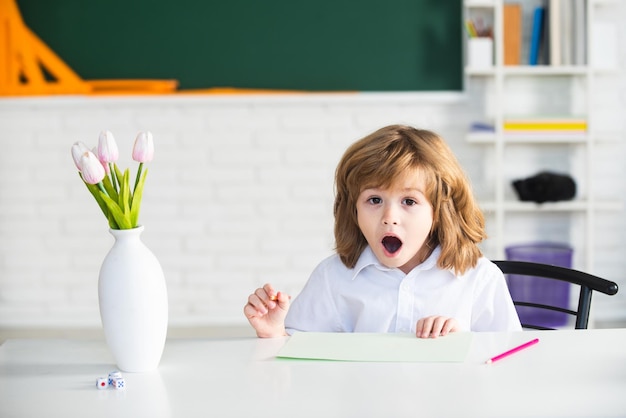 Excited kids in classroom at school Education and learning for child Amazed kids face