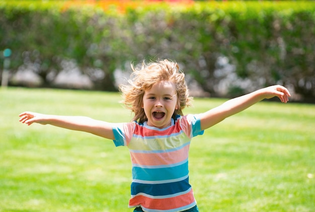 Excited kids happy child adorable lovely kid joyful portrait of small amazed child on green nature b