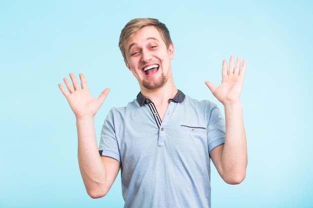 Excited man exclaimed in happiness, gestures actively, expressed great surprisement