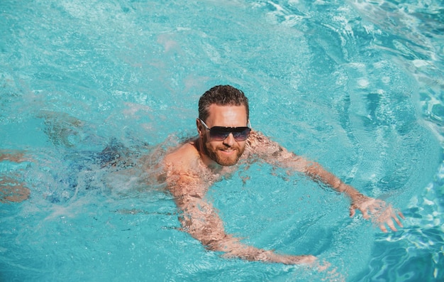 Excited man in swimming pool water pool spa resort summertime vacation summer man