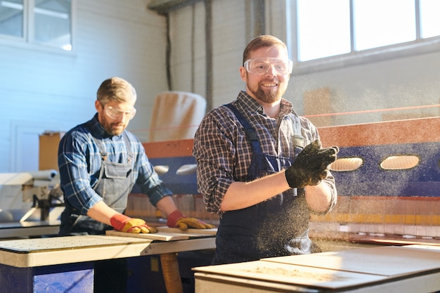 Excited man working at furniture factory