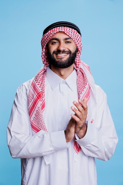 Excited muslim man applauding portrait