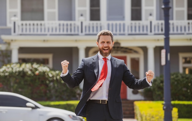 Excited real estate agent handsome amazinf businessman over new house