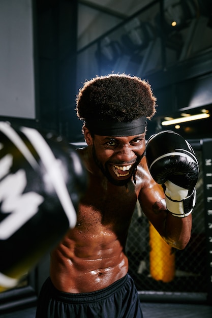 Excited shirtless Muay Thai boxer