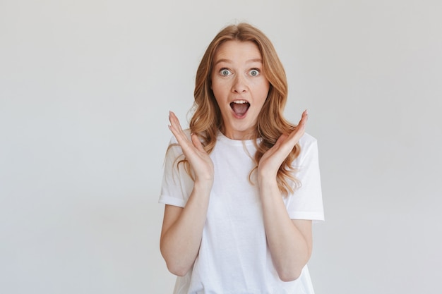 Excited shocked redhead woman