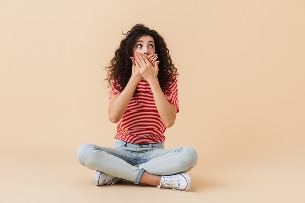 Excited shocked young woman looking aside.