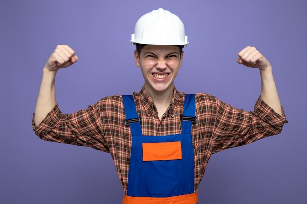 Photo excited showing yes gesture young male builder wearing uniform