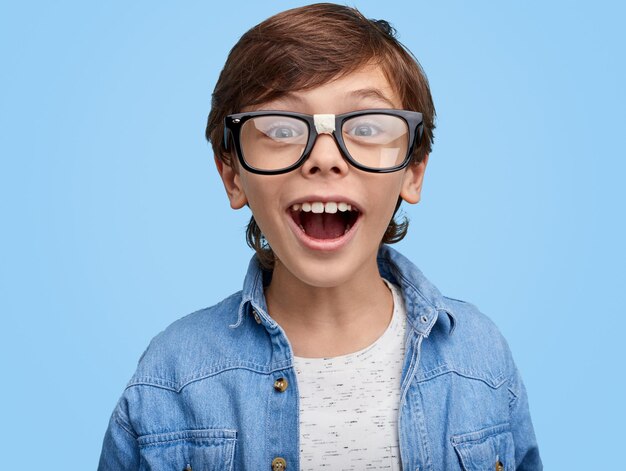 Excited smarty boy in eyeglasses