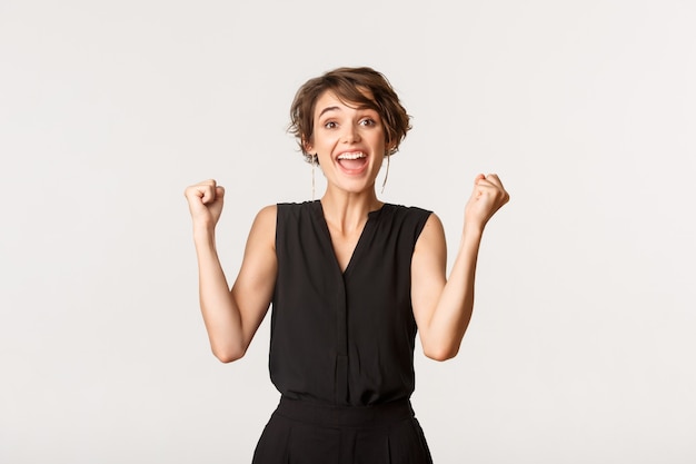 Excited successful young woman feeling lucky