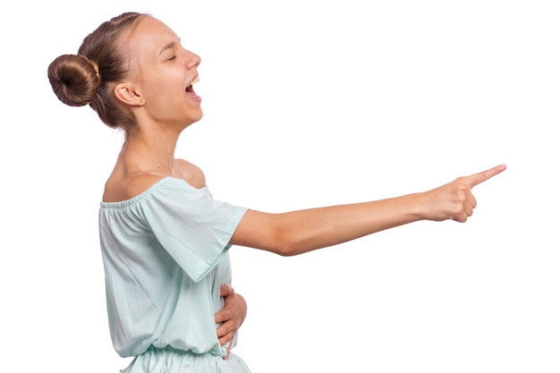 Excited teen girl pointing fingers away at copyspace side view isolated on white background