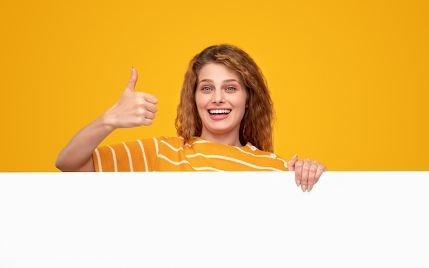 Excited woman approving blank poster