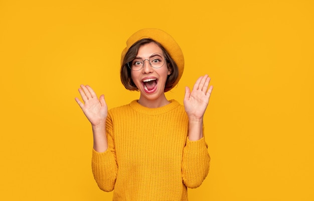 Excited woman in beret screaming