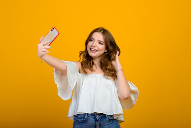 Excited woman with digital device. shocked girl holding smartphone, emotional