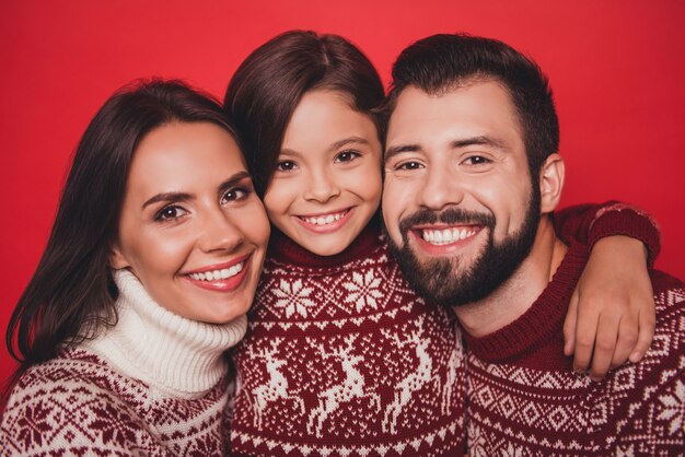 Excited woman with mom and dad in knitted cute traditional Christmas costumes