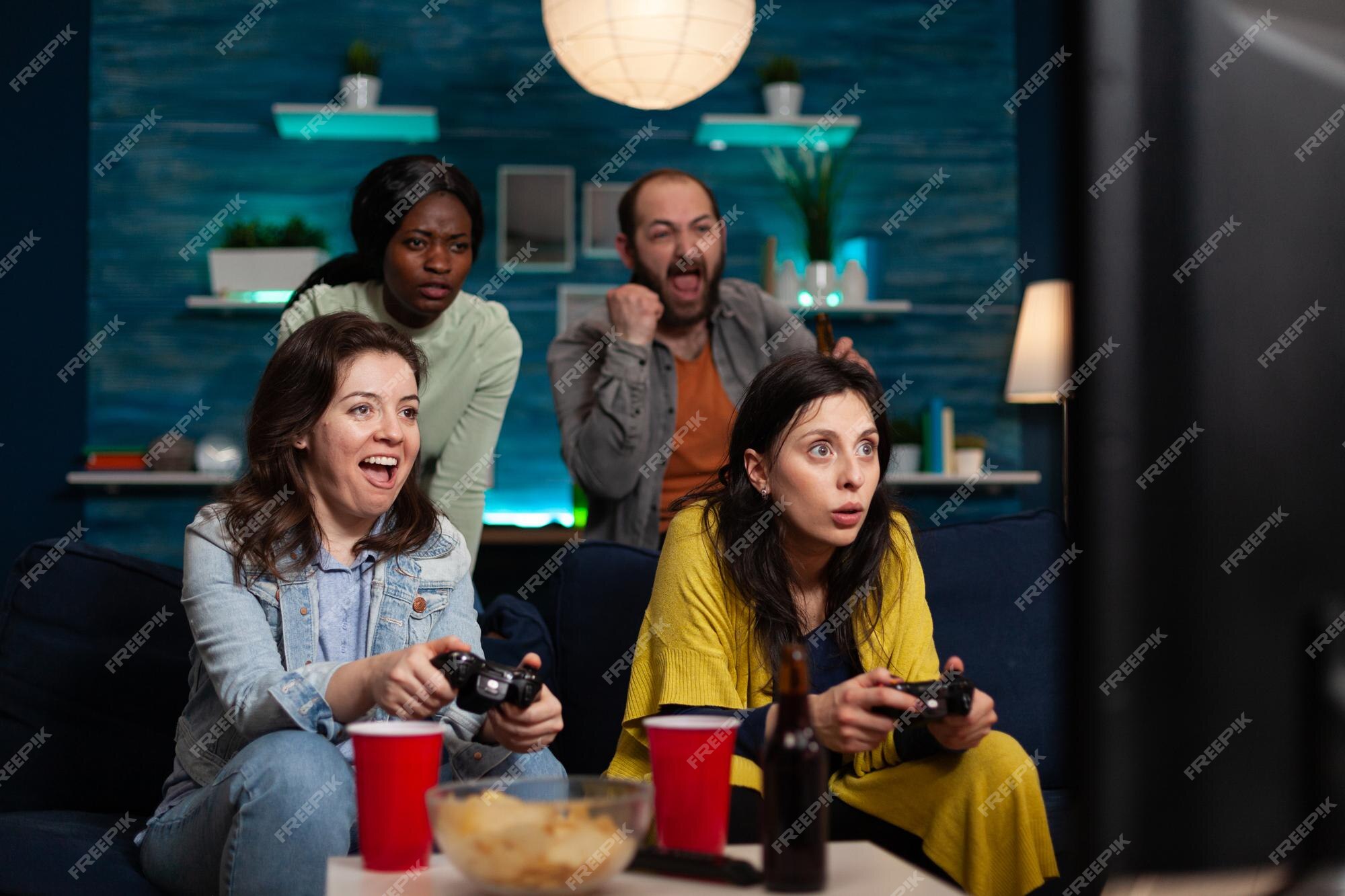 Multiethnic group of people playing online video games on tv