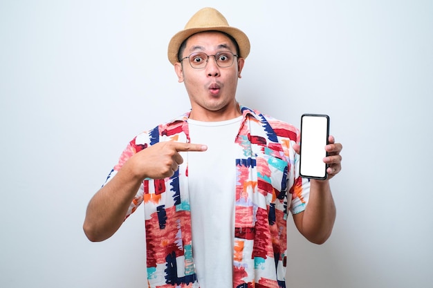 Excited Young Asian man shock showing phone screen at camera pointing at white phone screen