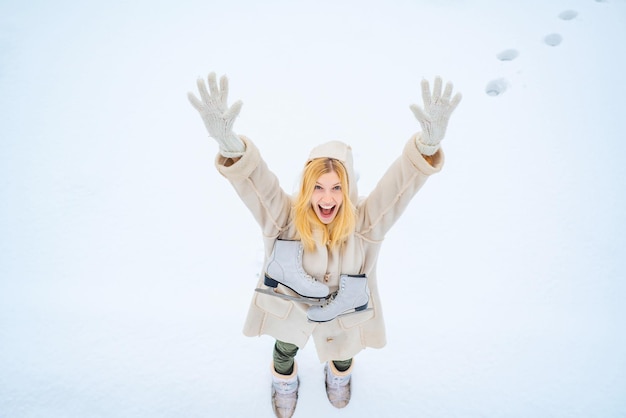 Excited young beautiful woman enjoy winter funny winter girl is going skate portrait of a happy amaz