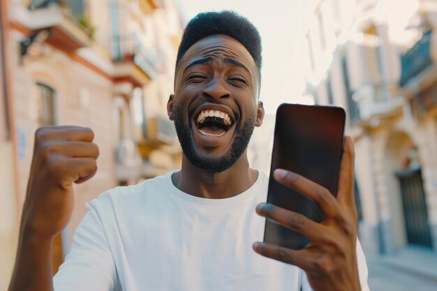 Photo excited young black man showing phone screen