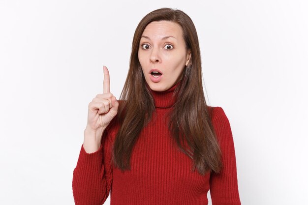 Excited young brunette woman girl in casual red clothes posing isolated on white background studio portrait. People lifestyle concept. Mock up copy space. Holding index finger up with great new idea.